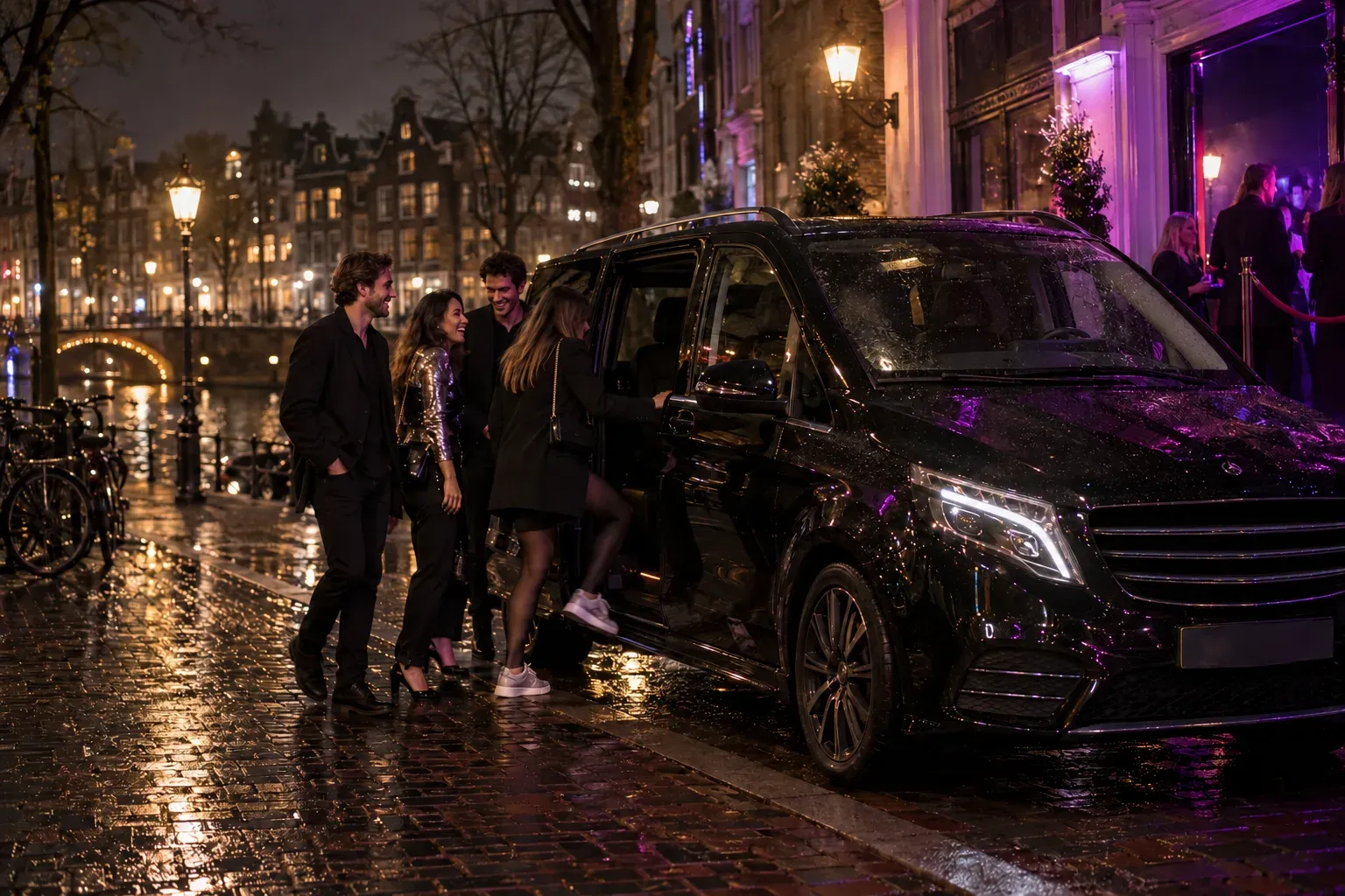 Friends get into a black taxi van outside a canal-side club at night, wet cobbles and purple light from the door.